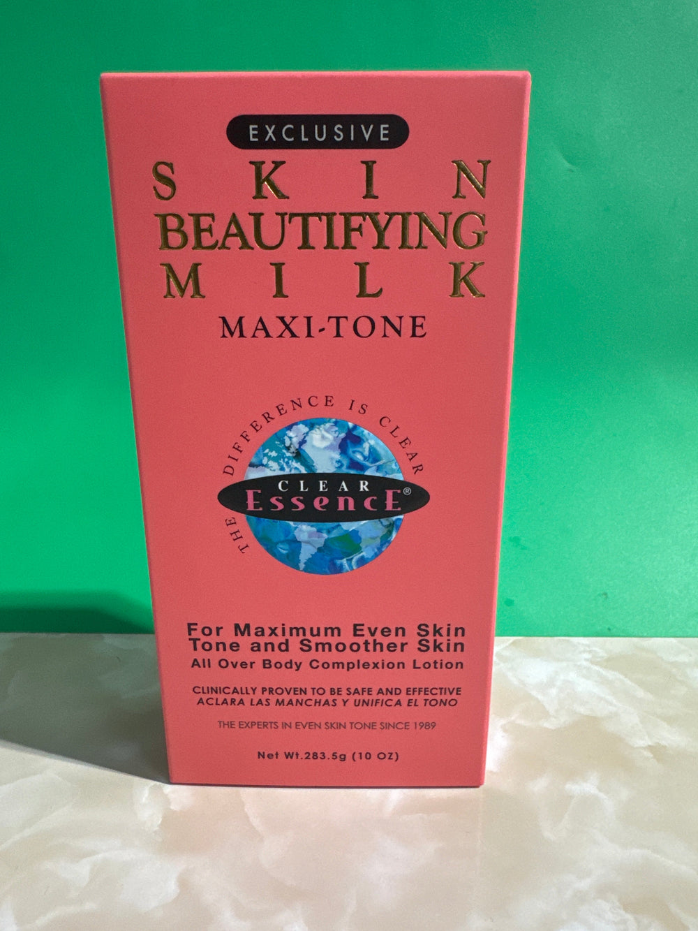 Red box of 'Clear Essence' Skin Beautifying Milk Maxi-Tone on a white background